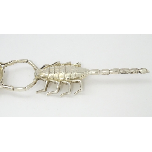 305 - A white metal spoon with Scorpion formed handle. Approx 7 3/4