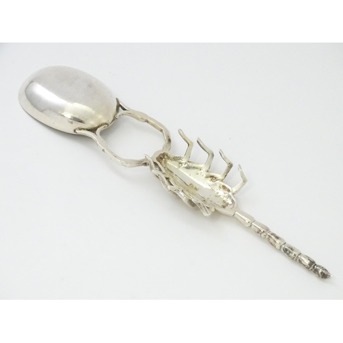 305 - A white metal spoon with Scorpion formed handle. Approx 7 3/4