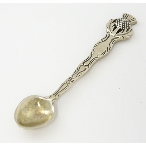 318 - A small silver spoon with Scottish silver thistle decoration to handle. Marked Sterling.   Approx. 2... 