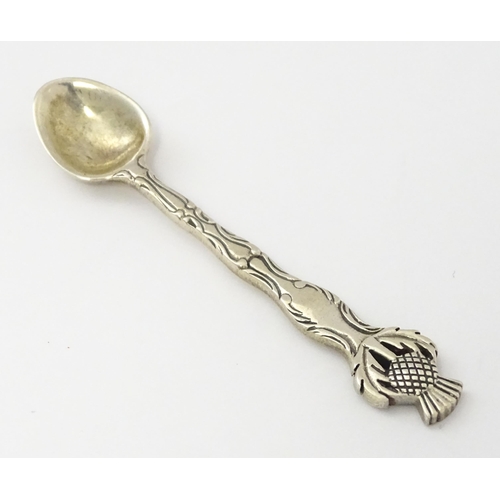 318 - A small silver spoon with Scottish silver thistle decoration to handle. Marked Sterling.   Approx. 2... 