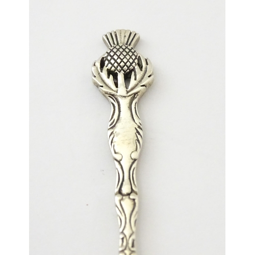 318 - A small silver spoon with Scottish silver thistle decoration to handle. Marked Sterling.   Approx. 2... 