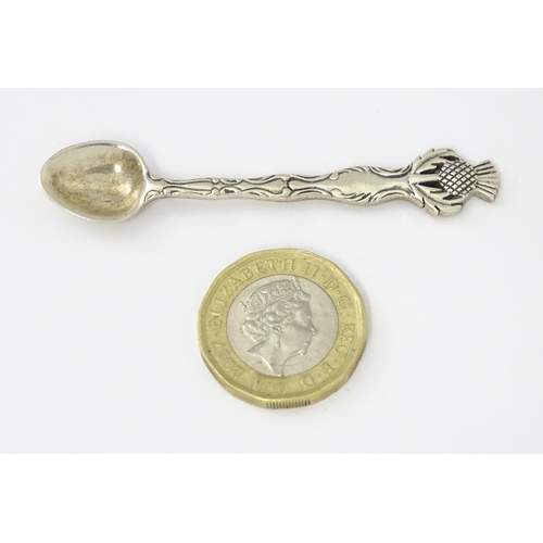 318 - A small silver spoon with Scottish silver thistle decoration to handle. Marked Sterling.   Approx. 2... 