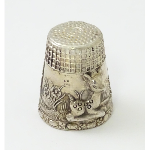 345 - A silver thimble with fawn / deer /  Bambi detail. Marked Sterling.