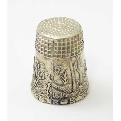 345 - A silver thimble with fawn / deer /  Bambi detail. Marked Sterling.