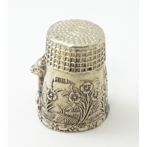 345 - A silver thimble with fawn / deer /  Bambi detail. Marked Sterling.