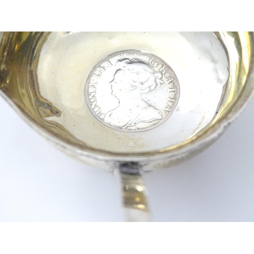 357 - A Silver toddy ladle with coin style detail to bowl depicting Queen Anne. Approx 15