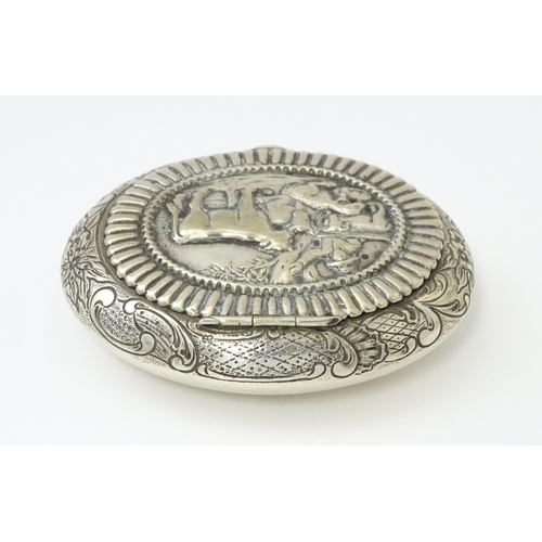 362 - A Dutch silver snuff box / tobacco box of ovoid form, the lid decorated with pastoral scene with fig... 