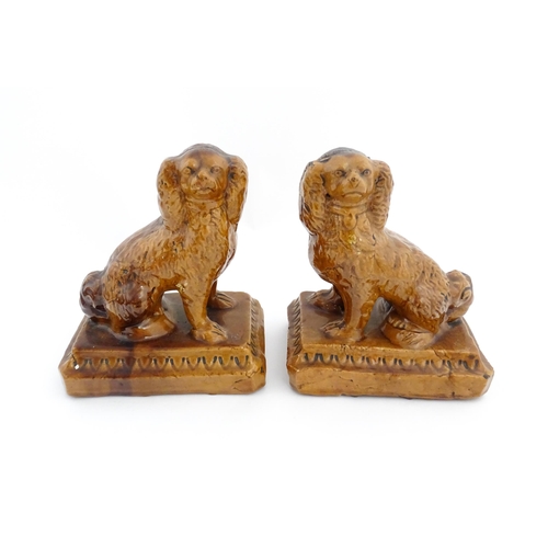 89 - A pair of 19thC salt glazed Brampton style pottery seated dogs. Approx. 8