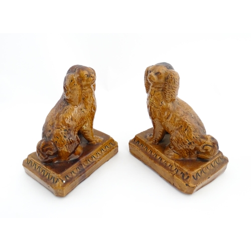 89 - A pair of 19thC salt glazed Brampton style pottery seated dogs. Approx. 8