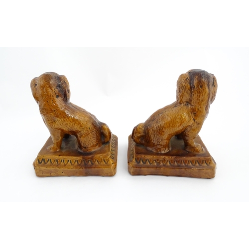 89 - A pair of 19thC salt glazed Brampton style pottery seated dogs. Approx. 8