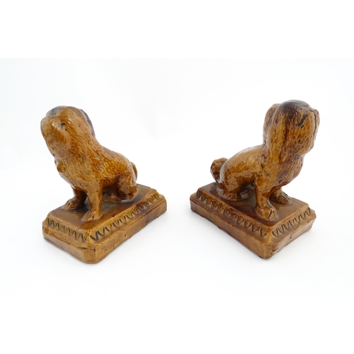 89 - A pair of 19thC salt glazed Brampton style pottery seated dogs. Approx. 8