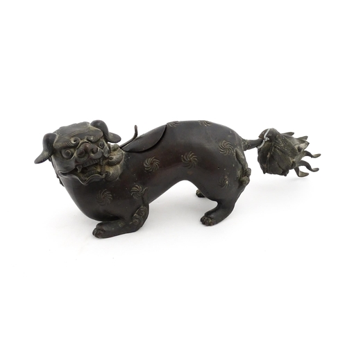 1003 - A Chinese bronze censer modelled as a temple lion / foo dog with engraved decoration. Approx. 12