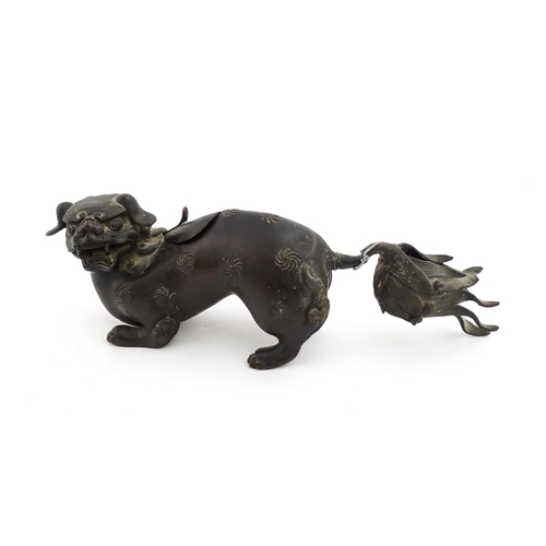 1003 - A Chinese bronze censer modelled as a temple lion / foo dog with engraved decoration. Approx. 12