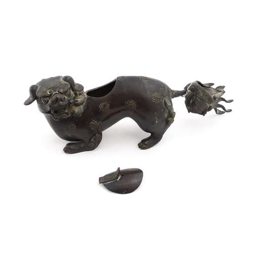 1003 - A Chinese bronze censer modelled as a temple lion / foo dog with engraved decoration. Approx. 12