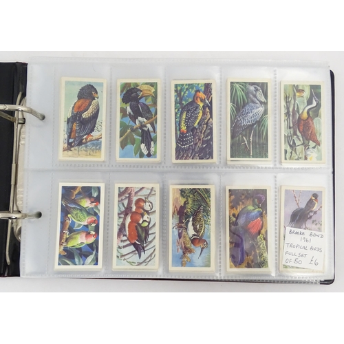 964 - A quantity of tea and cigarette cards within three albums, examples from various series including Jo... 