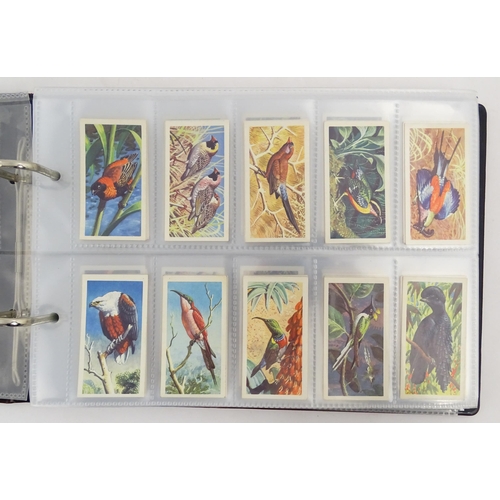 964 - A quantity of tea and cigarette cards within three albums, examples from various series including Jo... 