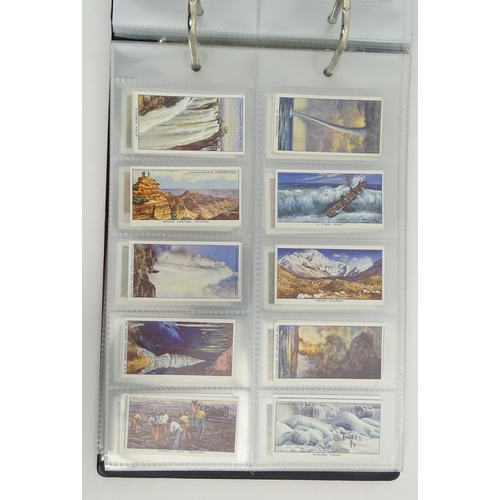 964 - A quantity of tea and cigarette cards within three albums, examples from various series including Jo... 