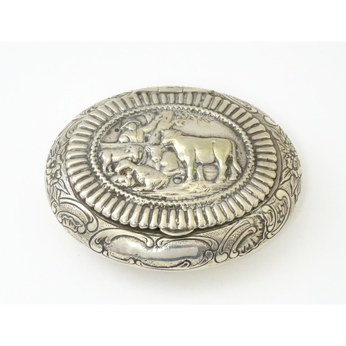 362 - A Dutch silver snuff box / tobacco box of ovoid form, the lid decorated with pastoral scene with fig... 