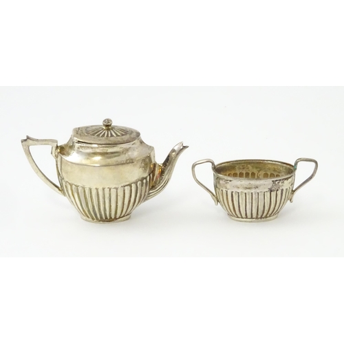 434 - A miniature / dolls house silver twin handled teapot and sugar bowl. Marked .925. Teapot approx. 1 3... 