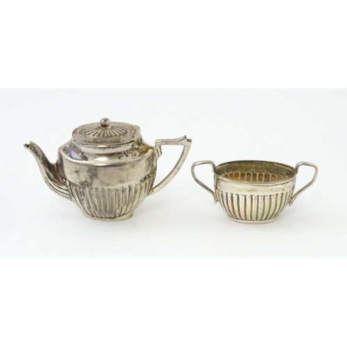 434 - A miniature / dolls house silver twin handled teapot and sugar bowl. Marked .925. Teapot approx. 1 3... 