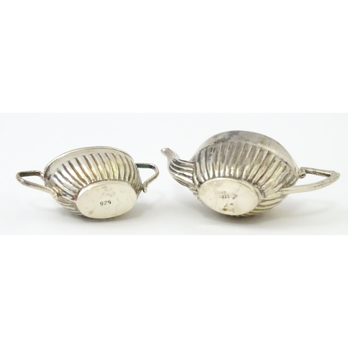 434 - A miniature / dolls house silver twin handled teapot and sugar bowl. Marked .925. Teapot approx. 1 3... 