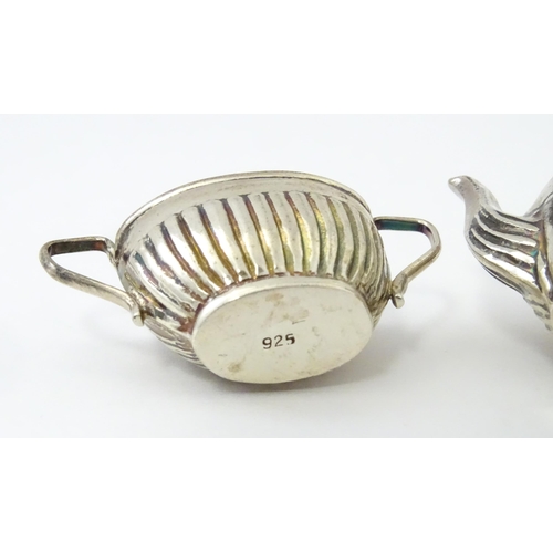 434 - A miniature / dolls house silver twin handled teapot and sugar bowl. Marked .925. Teapot approx. 1 3... 