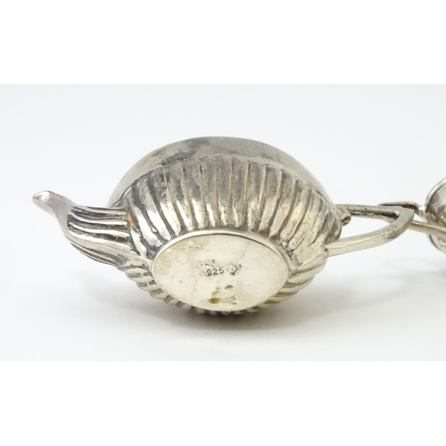 434 - A miniature / dolls house silver twin handled teapot and sugar bowl. Marked .925. Teapot approx. 1 3... 