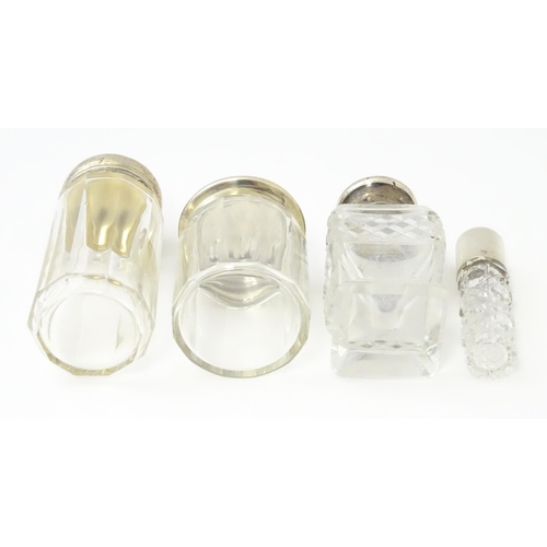 436 - Four assorted glass dressing table jars with silver tops, to include scent bottles etc. Largest appr... 