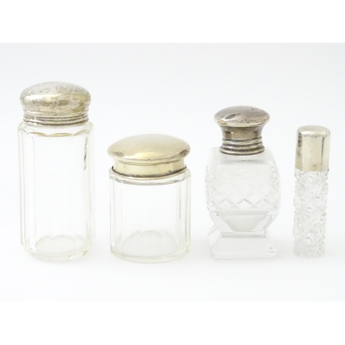 436 - Four assorted glass dressing table jars with silver tops, to include scent bottles etc. Largest appr... 