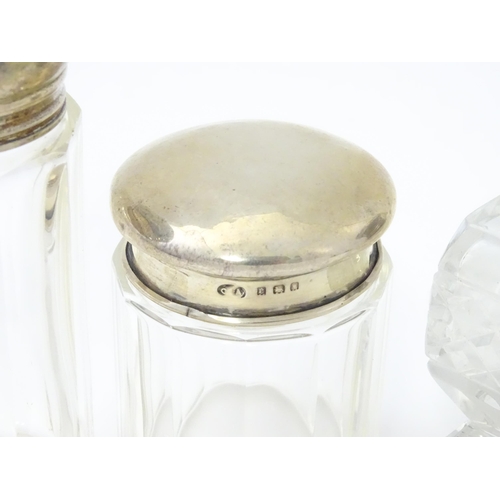 436 - Four assorted glass dressing table jars with silver tops, to include scent bottles etc. Largest appr... 