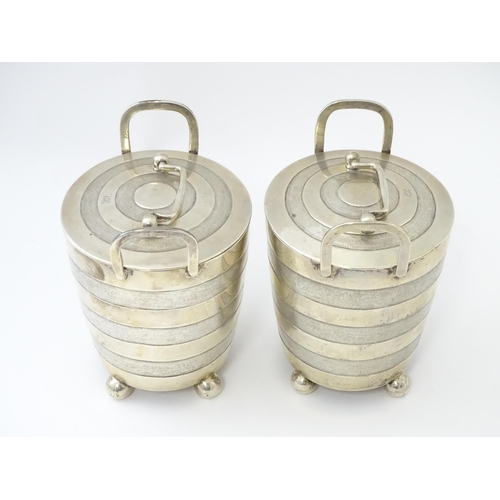 456 - A pair of unusual 19thC Indian Colonial silver tea caddies / lidded containers with twin handles and... 