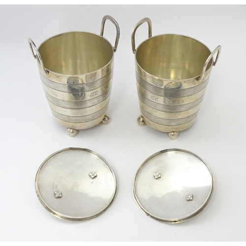 456 - A pair of unusual 19thC Indian Colonial silver tea caddies / lidded containers with twin handles and... 