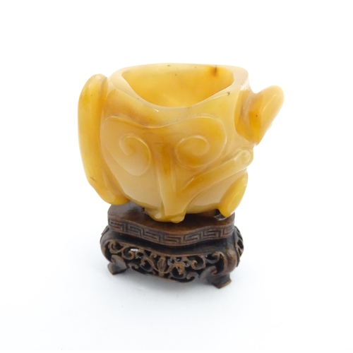 1008 - A Chinese carved agate brush washer with carved hardwood stand. Approx. 2 1/2