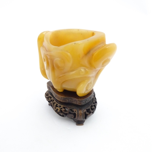 1008 - A Chinese carved agate brush washer with carved hardwood stand. Approx. 2 1/2