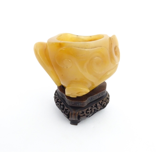 1008 - A Chinese carved agate brush washer with carved hardwood stand. Approx. 2 1/2