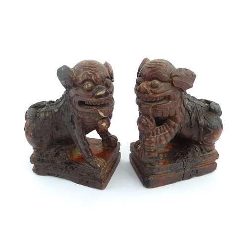 1011 - Two Chinese carved wooden foo dogs / guardian lions, one with a cub, the other with a ball, with tra... 