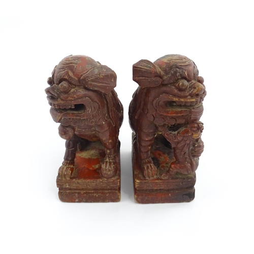 1011 - Two Chinese carved wooden foo dogs / guardian lions, one with a cub, the other with a ball, with tra... 