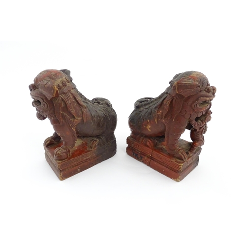 1011 - Two Chinese carved wooden foo dogs / guardian lions, one with a cub, the other with a ball, with tra... 