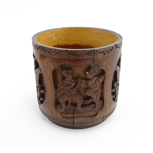 1019 - An Oriental carved bamboo brush pot with panelled decoration depicting figures and birds. Character ... 