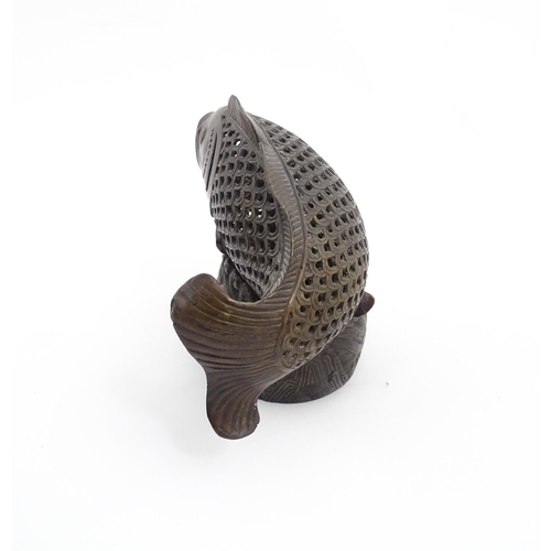 1020 - A Chinese bronze incense burner modelled as a fish on a stand decorated with crashing waves. Charact... 