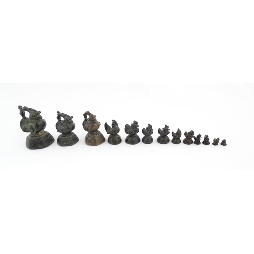 1024 - A quantity of Burmese graduated bronze opium weights modelled as crested ducks. Largest approx. 4 1/... 