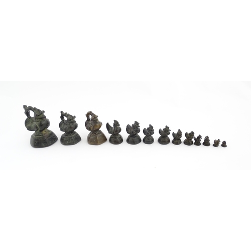 1024 - A quantity of Burmese graduated bronze opium weights modelled as crested ducks. Largest approx. 4 1/... 