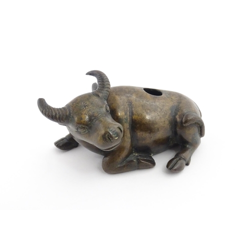 1025 - A Chinese Ming dynasty bronze censer modelled as a recumbent buffalo. Approx. 4 3/4