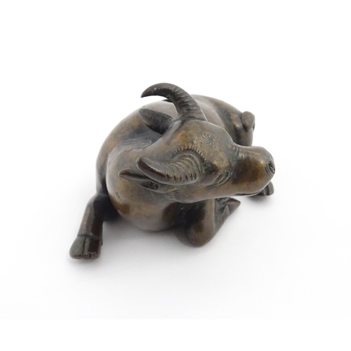 1025 - A Chinese Ming dynasty bronze censer modelled as a recumbent buffalo. Approx. 4 3/4