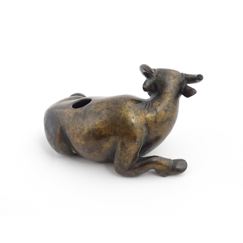 1025 - A Chinese Ming dynasty bronze censer modelled as a recumbent buffalo. Approx. 4 3/4