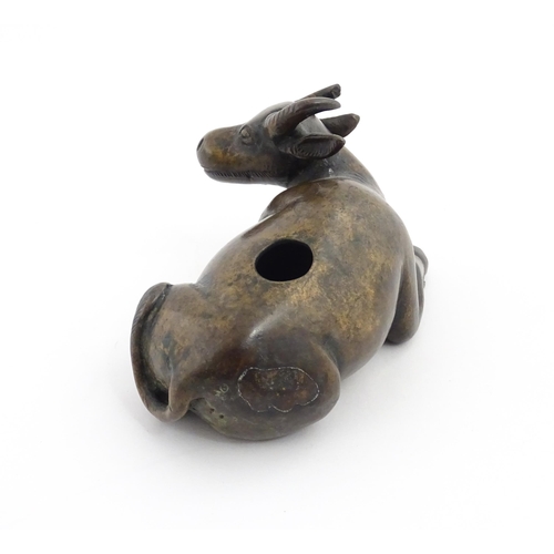 1025 - A Chinese Ming dynasty bronze censer modelled as a recumbent buffalo. Approx. 4 3/4