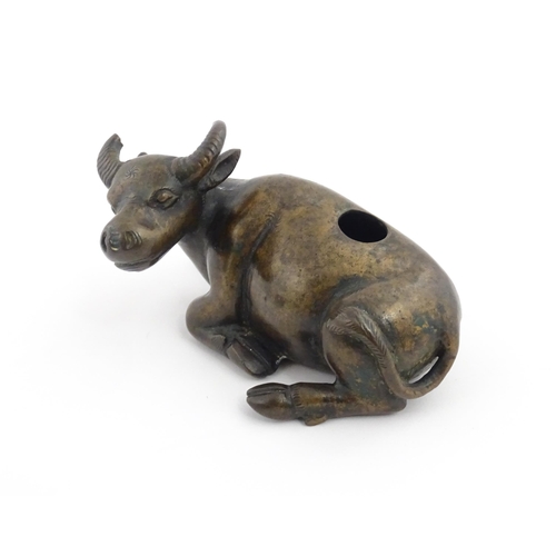 1025 - A Chinese Ming dynasty bronze censer modelled as a recumbent buffalo. Approx. 4 3/4