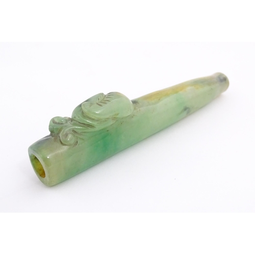 1026 - An Oriental jade coloured hardstone cheroot mouthpiece / holder with carved detail. Approx. 4 1/2