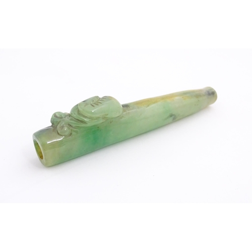 1026 - An Oriental jade coloured hardstone cheroot mouthpiece / holder with carved detail. Approx. 4 1/2