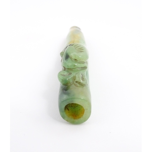 1026 - An Oriental jade coloured hardstone cheroot mouthpiece / holder with carved detail. Approx. 4 1/2